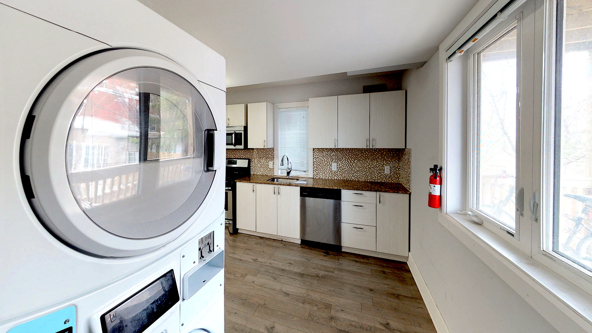 a kitchen with a washing machine and a window